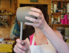 pulling the handle on the pot