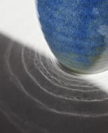 Sunlight catching an Argyll Blue pitcher and casting ripples onto white paper
